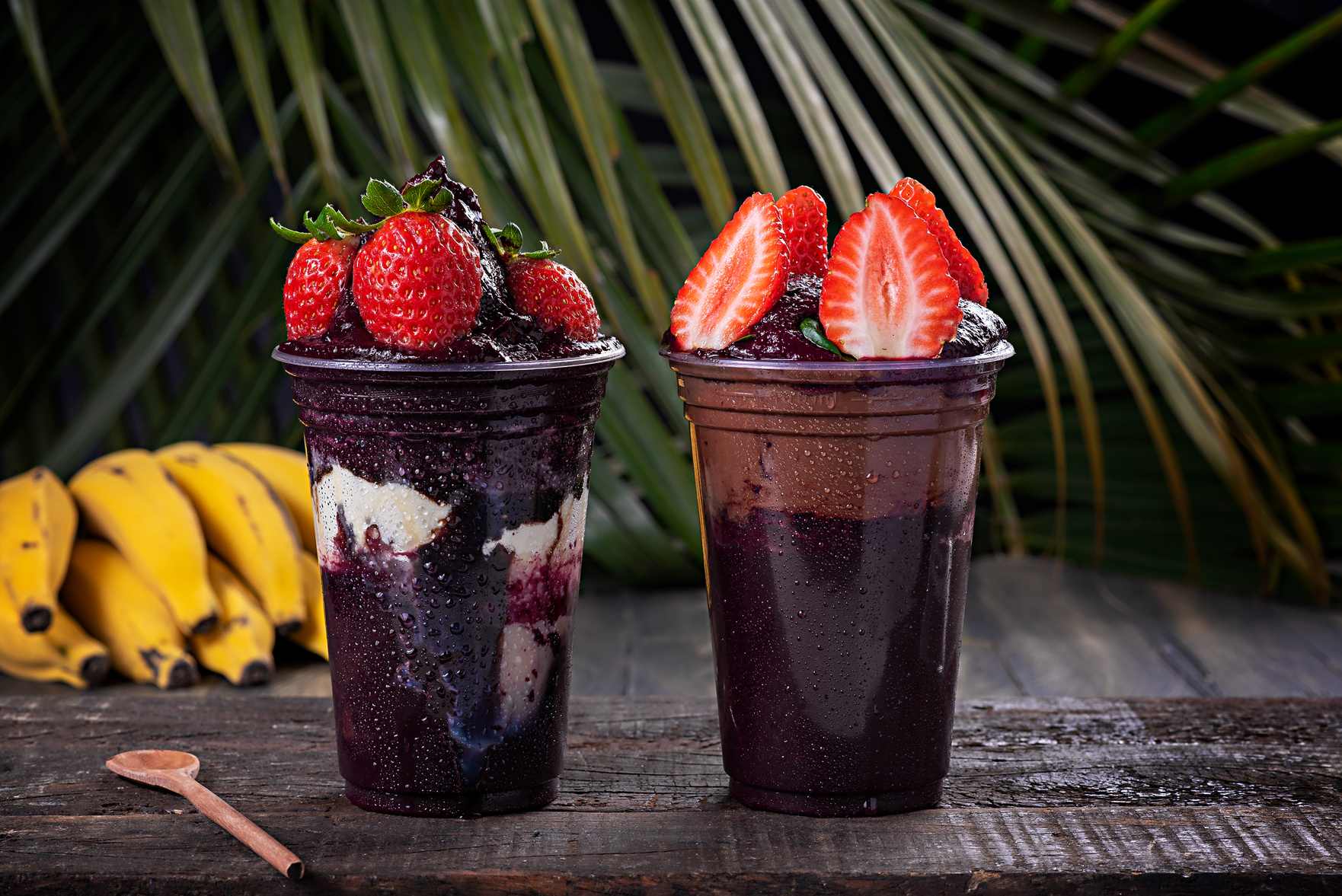 two cups of dessert with strawberries and blueberries