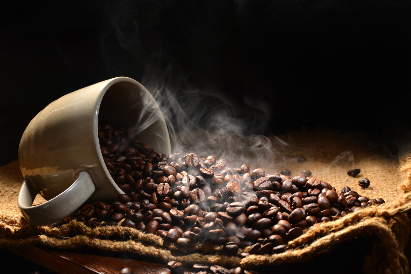 coffee beans and a cup of coffee on a wooden table - coffee stock videos & royalty-free footage